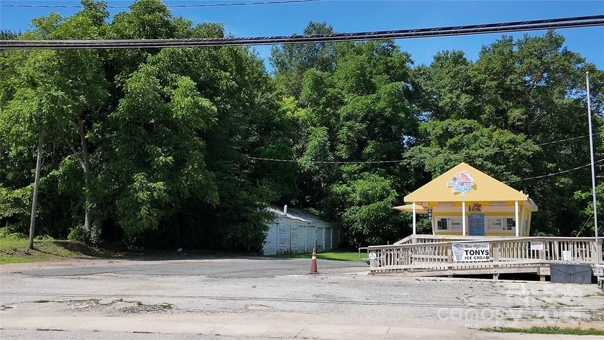 Corner commercial lot located at Dearborn St. and Catawba Ave. in downtown Great Falls. Features appx 329' of road frontage on two sides and includes a 7-bay garage structure, offering flexibility for a variety of potential uses. Zoned C-1 and R-1. The ice cream shop currently on site is not included in the sale—the business is leased, and the building is owned by the tenant and will not convey.