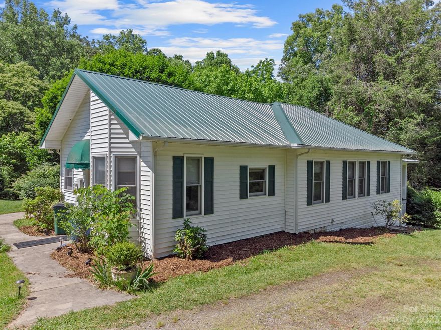 *BACK ON MARKET AT NO FAULT OF THE SELLER. Come see the new look!!* Walkable to downtown Weaverville and schools! This home is an early All Living on Main homestead in town, that has been lovingly cared for since it was built. Featuring high ceilings, a traditional layout with an easy flow, and beautiful views of nature out every window! Get a cozy and convenient home-- with a large yard-- right in town!! Wonderful front sitting porch and a large patio both overlook the treed lot with a peaceful creek running through it, with plenty of space cleared and a beautiful green lawn to enjoy. There is also a spacious "shop" beside the home, which is already roughed in with electricity and waiting to be finished into whatever your inspiration is! There is also plenty of land to expand if you want a bigger home, or to build some new homes. Whether a family home, vacation home, or vacation rental, this home has so much to offer!! Owner finance available with 20% down! 7%, 5-year balloon.