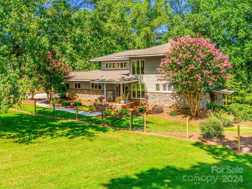 Privacy and tranquility abound in this large, custom home on 3 acres nestled in the heart of Lake Wylie.  Bordering a 5 acre pond, the property features abundant mature trees, a gently sloped yard, and has equestrian zoning for horse lovers.  This contemporary home has a massive, 2-story open floor plan that is delightful for entertaining.  With 3 levels, large bedrooms, and substantial premium upgrades throughout, the home can suit many lifestyles.  A composite deck on the main level, a spacious patio on the lower level, and a large fire pit by the pond provides for tremendous outdoor living fun.  With garage parking for 4 and a dedicated RV pad, there is ample room for cars and toys alike.  Additionally, a separate in-law studio suite in the detached garage makes this home perfect for multi-generational living.  CSD Schools, low taxes, and close proximity to the lake make for a rare find in the Lake Wylie community.