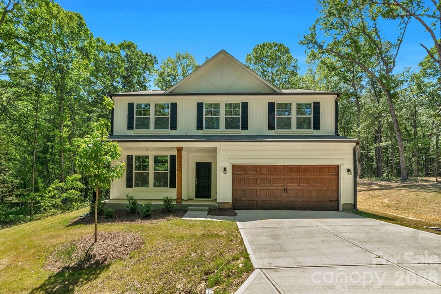 Price dropped for Quick Sale! Discover the perfect blend of modern comfort and country charm with this beautiful new construction farmhouse-style home tucked away on 1.10 private acres at the end of a long, secluded driveway. Designed for peaceful living, this two-story home offers all the benefits of new construction without the restrictions of an HOA.

The inviting white exterior with wood columns sets the tone for its warm farmhouse appeal. Inside, you’ll find an open-concept main floor that’s perfect for entertaining — featuring a spacious kitchen with a large island, breakfast area, bar seating, and a separate dining area. The open layout flows effortlessly into the bright living room, where large windows overlook the tranquil, wooded backyard — creating a cozy, relaxed atmosphere.

Upstairs, enjoy a thoughtful layout with three bedrooms, two full baths, a loft area, and a convenient laundry room. The primary suite offers comfort and privacy, complete with a beautiful ensuite bath and ample closet space.

Step outside to your back patio and take in the peaceful surroundings — ideal for morning coffee, evening gatherings, or simply enjoying nature. The two-car garage provides plenty of space for parking and storage.

If you’ve been searching for a new construction home with space, privacy, and no HOA, this one checks all the boxes. Come experience quiet country living just a short drive from Monroe, Waxhaw, and Lancaster!