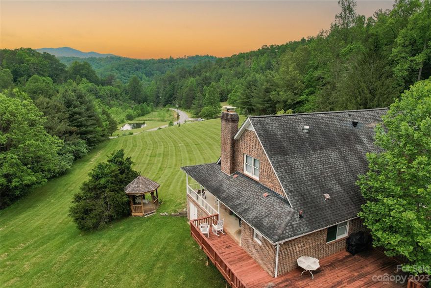 Get ready to be blown away by the breathtaking views from this sprawling 5-acre property with no restrictions in the picturesque Burningtown community. The home is a solid brick beauty, offering over 3500 sq ft, with an unfinished lower level waiting for your personal touch. Inside is a spacious kitchen, a dining room, a massive primary bedroom with a huge walk-in closet, two living areas, a charming three-season sunroom, 3.5 bathrooms, and a laundry room. On the upper level, discover two more bedrooms, a bathroom, a game room/workout space, and an office, as well as a separate entrance and deck. Park your cars in the two-car garage on the main level or in the one-car garage on the lower level. The lower level is equipped with a wood stove, plumbing for a bathroom, chairlift access from the utility room, and loads of storage. Stay cozy with a gas log fireplace in the den and wood stove in the living room.