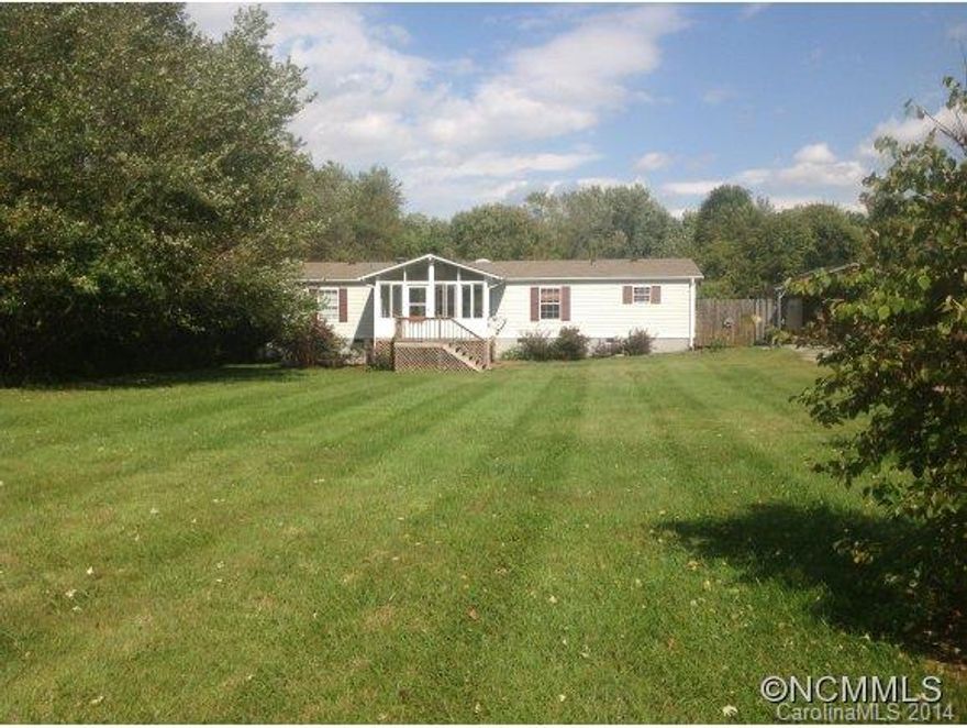 MILLS RIVER AREA - .76 acres of level land with large rear yard fenced on three sides and large front yard.  Two decks, one with SunSetters Retractable awning and one with carport cover.  Sunroom on front. Over 1500 square feet 1996 Fleetwood double wide with 2 bedrooms, 2 baths and a third room with walk-in closet, formal dining room, large living room, updated kitchen & separate laundry room.