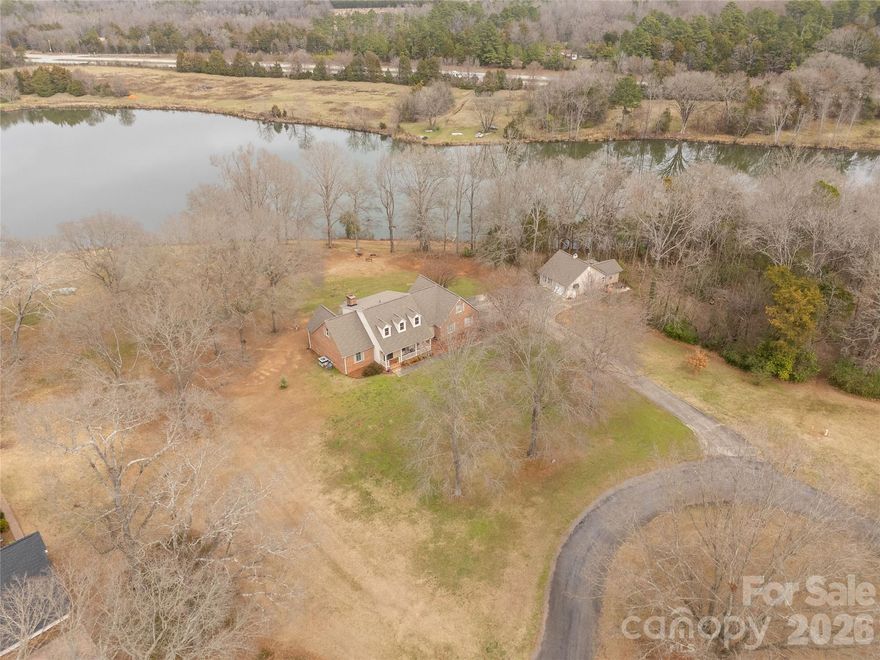 Tucked into one of Lancaster’s best kept secrets, this lakefront retreat on Culp Lake is the kind of home that makes you slow down… and then never want to leave. Welcome to a rare gem in a private enclave of just eight homes, perfectly positioned between Indian Land and Lancaster, just south of Hwy. 5.  

No HOA. No cookie cutter sameness. Just space, privacy, and front row seats to nature.  

Set on just over two acres along the shores of Culp Lake, a serene 13 acre stocked lake, this stately brick home offers beautifully updated living space designed for both everyday comfort and unforgettable gatherings. Inside, rich hardwood floors stretch across the main living areas, accented by elegant crown moldings and thoughtful architectural details. Updated finishes blend timeless style with modern ease, creating rooms that feel polished yet welcoming. With four spacious bedrooms, three and a half bathrooms, and a dedicated home office, there is room to live, work, and host with ease. with the primary suite on the main floor, the layout flows effortlessly for entertaining. Large windows frame peaceful water views that shift with the light of the day. A beautiful sunroom invites you to unwind year round, wrapped in natural light and lake views. Step outside onto the back deck overlooking the water, where morning coffee feels quieter, sunset dinners feel richer, and weekends naturally gather friends and family. Outside, the expansive lot gives you room to breathe, play, garden, or simply enjoy the stillness. Fish from your own shoreline in the stocked lake, launch a kayak, or watch the reflections ripple across the water at dusk. It is lake life without the chaos. Car enthusiasts, hobbyists, or anyone needing extra space will appreciate the two-car attached garage plus a one-car detached garage complete a half bath and office area perfect for storage, a workshop, or that extra vehicle. This is not just another listing. It is a rare opportunity to own lakefront property in a highly desirable Lancaster location where homes rarely become available.

Privacy. Space. Water views. Updated elegance AND only seven neighbors.

If you have been waiting for something truly special, this might be the one.