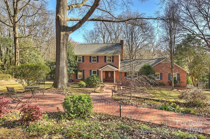 Discover this private oasis on nearly an acre with a fenced backyard and brick-paved entry paths. Featuring newly installed wood floors and a completely renovated kitchen, this home merges elegance with comfort. The main level hosts an extended primary suite with a luxurious bathroom, including a floating vanity and standalone tub. Enjoy natural light from picture windows overlooking the expansive yard from the primary bedroom. Upgrades include brand new windows, a wood-burning fireplace surrounded by detailed built-ins, new lighting, refinished staircase, and more. Ample storage is available in the unfinished basement and garage. Located a mere 10-minute walk from downtown Huntersville, enjoy easy access to shopping, dining, parks, and the greenway. Experience the perfect blend of privacy, outdoors, and convenience in this beautifully updated home.