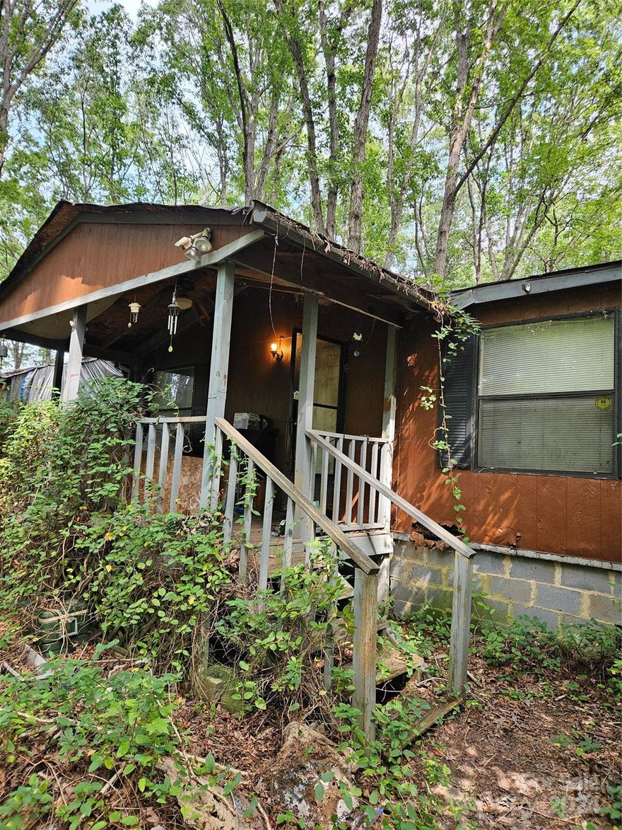 Land and Investor Special!  3 Bedroom, 2 Bathroom doublewide on 4.68 acres known as Lot 2 (Lot 1 - 501 Powell Road is not included in the sale) and located in the county off Twin Lakes Road.  Home needs TLC and repairs.  A wonderful location that is near schools, shopping, restaurants and the hospital plus convenient to Rock Hill, York, Lake Wylie and minutes to I-77 for commuters.  Seller is willing to provide a $10,000 buyer credit for removal of double wide at asking price.