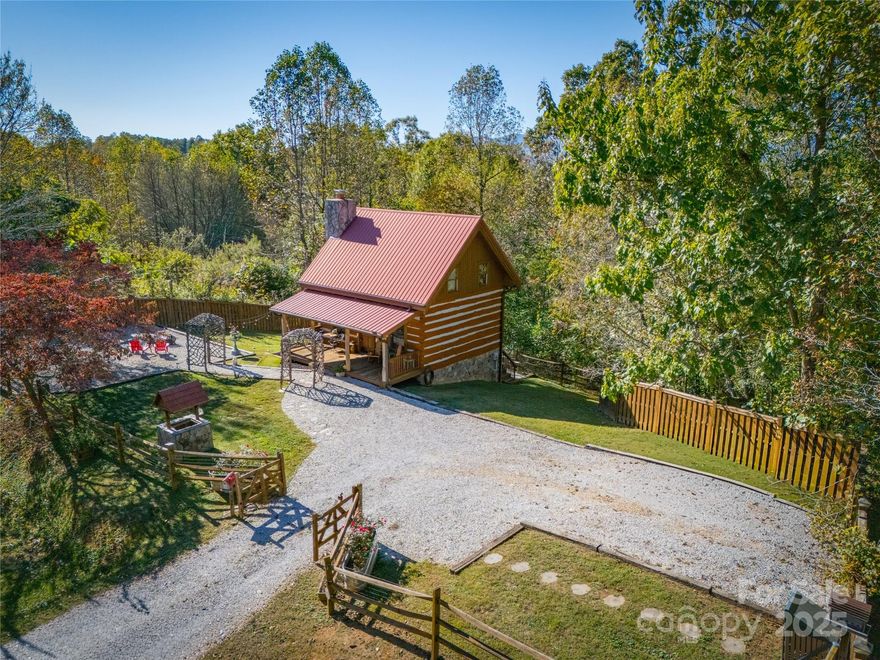 This well-cared-for log cabin offers mountain views along with easy access to nearby amenities. Built with attention to detail and quality materials, the home has been consistently maintained over time. A recent professional home inspection has been completed and reflects the property's excellent condition.

The main level features an open living area with hardwood floors, a floor-to-ceiling stacked stone fireplace with Buck Stove gas logs, and a well-appointed kitchen with high-end appliances. A bedroom and full bath are also located on the main floor, providing convenient single-level living.

Upstairs, the primary suite spans the entire second floor and includes beamed ceilings, two sitting areas, and a half bath. A separate exterior entrance leads to a walkout basement offering 537 square feet of unfinished, climate-controlled space—ideal for a gym, workshop, or storage.

Outdoor features include a fenced yard with a fire pit and grilling area, as well as a balcony off the kitchen that offers views of the mountains and surrounding landscape.

The home is on a private well and septic system and is being sold fully furnished, with a few personal exclusions. For more information or to request the inspection report, don't hesitate to get in touch with the listing agent.