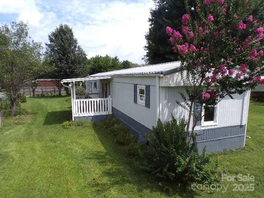Located on a fenced half-acre lot, many attractions surround this home-; Lake Junaluska, the Great Smoky Mountains, and the Blue Ridge Parkway, to name a few.  Returning to the simple way of living, this home features 2 bedrooms with en-suite bathrooms, divided by an open living room and kitchen.   The specialties include a front covered porch overlooking the scenery. The enclosed rear deck consists of a ramp for easy access. Additionally, there are 4 outbuildings on the property, with one including an electrical subpanel and workbenches.  The sale of the property is being made on an “As Is”,“Where "As Is","Where Is”,"with All Faults” basis. The seller is a trust of the owner who passed away earlier this year, and therefore makes no warranty or representation, express or implied, including warranties of merchantability or fitness.