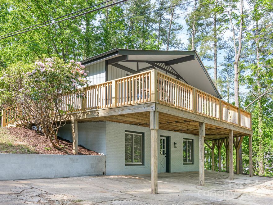 Discover this beautifully renovated home in a highly sought-after North Asheville location. Every detail has been updated, including a brand-new roof, HVAC system, kitchen, bathrooms, floors, and fixtures. The spacious main-level primary bedroom offers comfort and convenience, while the open concept living room and stunning new kitchen, complete with granite countertops and all new appliances, seamlessly flow together. Enjoy gatherings in the large dining room, which opens directly to an expansive deck—perfect for outdoor dining or relaxing. The lower level features a generous living room, two additional bedrooms, and a full bathroom, offering great flexibility for families and guests or a home office setup. This turnkey home blends modern updates with timeless charm in one of Asheville’s most desirable neighborhoods.