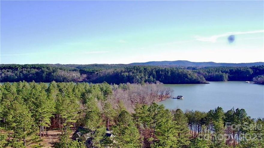 WATER VIEW PREMIUM LOT! If you're looking to build your dream home with a stunning lake view, look no further! This 1.174 acre lot has it all! You're right across the street from the beautiful Lake Rhodhiss and a short walk from the pool and club house.  The Waterfront Club communtiy offers 3 separate lake access points for boating, kayaking, etc. along with a Tiber frame Pavilion with a fire pit. You're close to grocery stores, restaurants, and shopping. Perfect for your primary home or a fun vacation spot, only 1 hour from Asheville NC and Charlotte Douglas Airports.