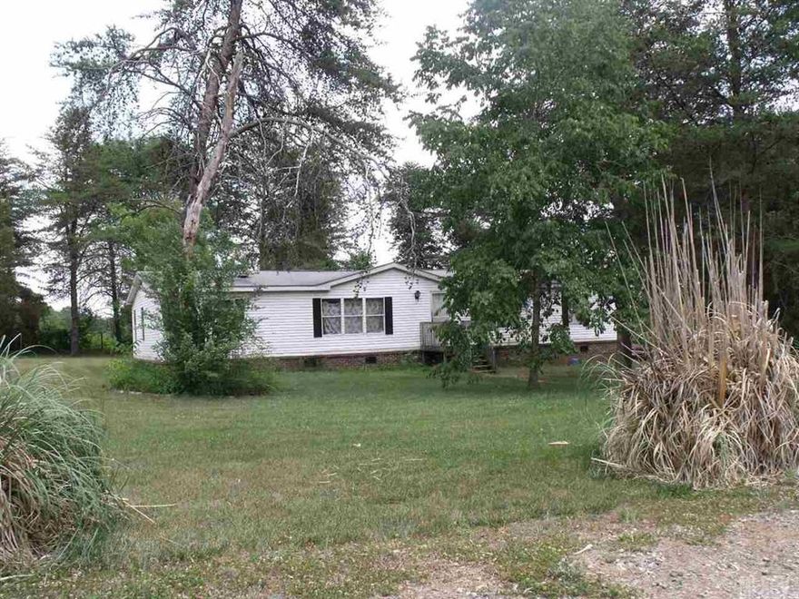 Over ten acres of fenced wooded and partially cleared acreage.  Creek on property.  Two nice storage buildings and 3 covered carports.  Private and wooded acreage consists of two parcels.  Mobile on 2 acres and remaining 8+ acres on separate parcel behind mobile.  (#369701096440 & 369701086955)