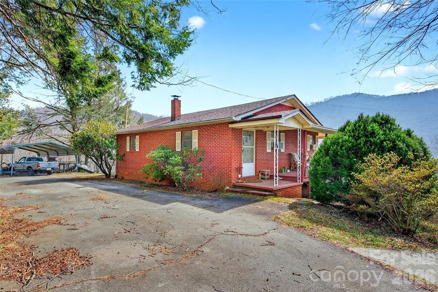 Welcome to this charming two-level brick home featuring 3 bedrooms plus a versatile bonus room or office and 2 full baths, all complemented by beautiful views. With separate entrances on each level, this property offers excellent potential for a two-level rental with the addition of a small upstairs kitchen. Enjoy easy paved access leading to a convenient circular drive. A fenced yard off the lower-level patio provides added functionality. This place is about to pop with colors of beautiful rhododendron and other native flora.