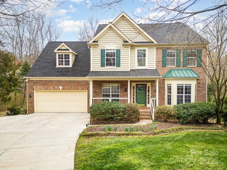 RARE FIND: Beautifully renovated 5 bed, 3.5 bath home with basement and pool in the award-winning Fort Mill School District. The main floor boasts hardwood floors, neutral paint and a spacious open concept layout. The updated kitchen features an oversized island, granite countertops, stainless steel appliances, and custom cabinetry. The family room has a cozy gas fireplace and custom built-ins, while the dining room and living room are perfect for entertaining. Relax and unwind upstairs in the primary suite with vaulted ceiling, huge walk-in closet and stunning spa-like bath. Three additional bedrooms, full bathroom, loft, and dream laundry room complete the second floor. The basement is equipped with a large rec room, dry bar, bedroom, full bathroom and flex space - ideal for hosting guests. Enjoy the serene outdoor setting of the wooded backyard with gunite pool, screened-in porch, deck, hot tub and covered outdoor space.  Oversized 2-car garage and mudroom...this home has it all!
