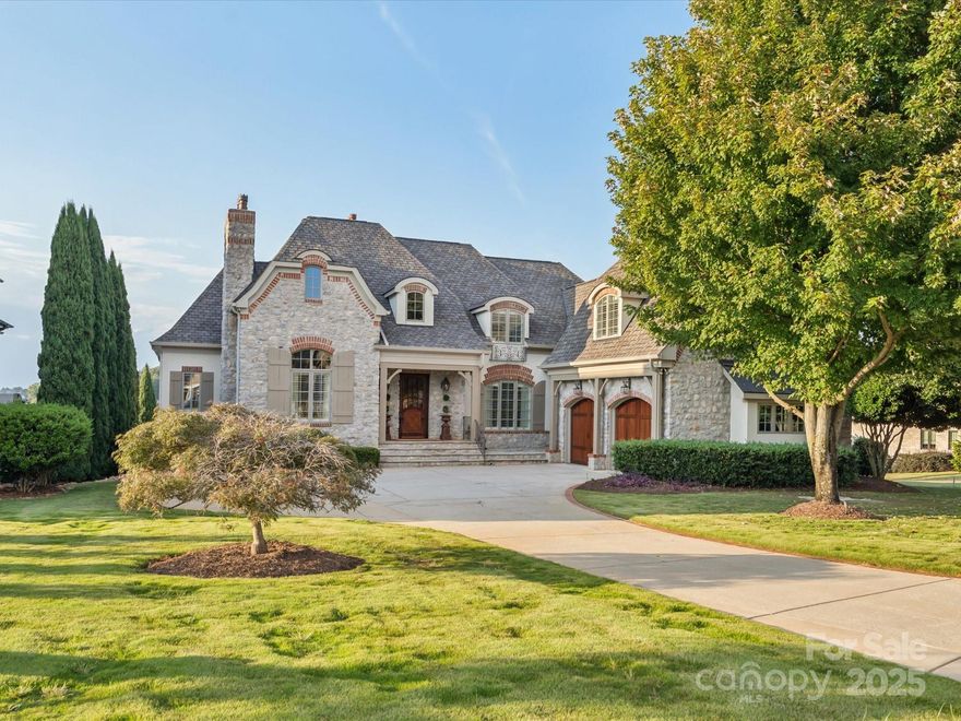 “A picture is worth a thousand words” is an understatement for this phenomenal French Country premier home located in the gated Joslin Pointe community!  From the beautiful curb appeal to the amazing views of Lake Wylie, there is not a detail that has been compromised in this place.  The main floor primary bedroom suite features gracious space and views, luxurious bathroom with tile shower, freestanding soaking tub, and dual vanities, as well as an expansive primary closet with packing island and washer/dryer.  The gourmet kitchen features a 60” Wolf dual fuel range with double griddle, microwave drawer, Bosch dishwasher, built-in Sub Zero appliances including refrigerator, ice maker, two freezer drawers, and wine chiller.  The island, dining area, and brand new custom automated shades will be great assets as you entertain your guests.  The dining room is perfect for sharing both formal meals or everyday dinners around the table.  Cozy up by the two-story stone fireplace with gas logs in the family room that opens to the kitchen and provides a doorway to the covered veranda.  The living room, with the second gas fireplace on the main level, is ideal for privacy, if needed – and could easily serve as a home office. The gorgeous spiraling staircase in the foyer and a second staircase off the kitchen lead to a second floor that features an apartment suite with bedroom, private bath, and kitchen-ready space with built-in refrigerator/freezer drawers. Two additional bedrooms and bathrooms, as well as a sitting area and flex room complete the upper level.  You will love the possibilities this space provides, including the storage.  Don’t forget to check out the water views! As if this was not enough, you will be enthralled with the finished basement area that boasts a second kitchen, incredible entertainment space with pool table, family room with stone fireplace and gas logs, dining area, movie theater with stadium seating and enhanced lighting system, bedroom, full bath, and wine storage room.  In addition, there is a second washer/dryer on the lower level.   Outdoor living and socializing will take on new meaning with the covered verandas on the main level and lower level that provide an incredible space for you and your guests to relax and enjoy the lavish life of lakefront living.  Relax on your private beach and enjoy the incredible sunsets across the lake. Looking for a place for your boat?  This one has the perfect spot with a private dock and boat lift!  Come see all this enchanting home offers and picture yourself as the next residents of 527 Joslin Pointe Lane.