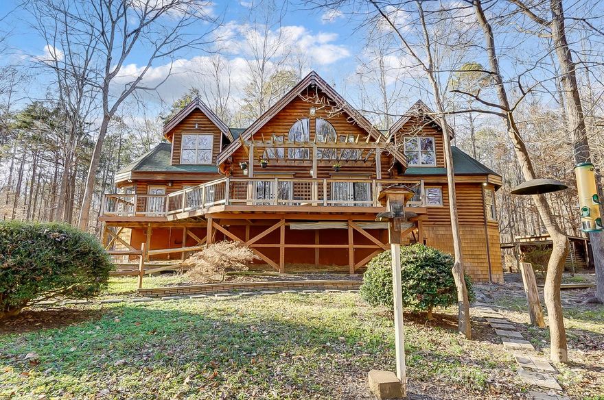 CUSTOM HERITAGE CEDAR LOG HOME is a true Oasis minutes from Waxhaw Center City. Nestled on 3.25 acres in this non HOA community, 7404 Mockingbird Lane is surrounded by nature, giving you the PRIVACY you have been looking for! The heart of this home is the Two story Great Room w/ gleaming wood flooring. Soaring ceilings showcase the workmanship of this Stunning Log Home. TWO huge decks; one covered and one open. FP w/new gas logs. Cooks kitchen w/Island gas cooktop and Bosch wall oven/microwave combo. Large Primary w/ensuite and vaulted alcove. Bonus/flex room on main has a closet and can serve a multitude of uses. Upstairs has a large loft for another "flex" space and 2 bedrooms w/walk in closets and cedar storage. 2 full baths w/one as an ensuite. HUGE basement w/laundry/workshop area and separate craft/office/hobby room. Covered parking and shed on property. So many wonderful attributes to this home that will be appreciated and enjoyed. This home truly has it all! Welcome Home!