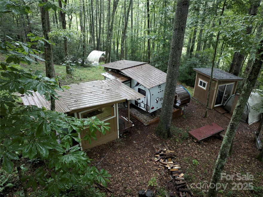 Discover 2.25+ acres of pure charm in Spruce Pine—once the creative retreat known as The Clever Trees Forest Park Studio. Just minutes from the Blue Ridge Parkway and world-famous Penland School of Craft, this property is ready to inspire your next chapter.
Nestled among the trees, you’ll find a cozy sleep shed, a small camper (included!), and multiple storage structures—perfect for artists, dreamers, or anyone craving a peaceful mountain escape. A thoughtfully graded home site is already waiting for your vision, making it easy to bring your dream home to life. 
Bonus: Seller is including custom house plans to help jumpstart your build!
Whether you’re looking for a private retreat, creative hideaway, or future forever home, this property offers endless possibilities in one of the most beautiful and creative  corners of Western North Carolina. Don’t miss your chance to own a slice of mountain paradise!