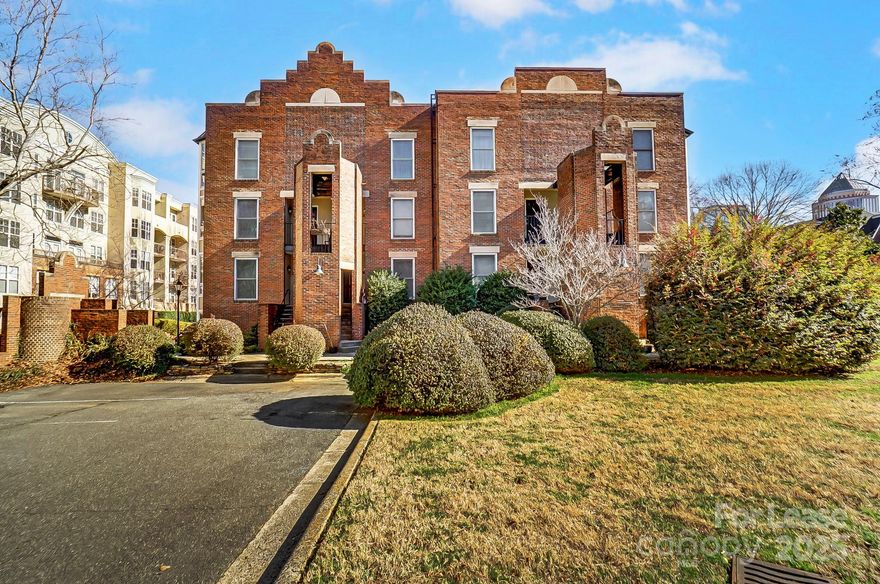 Don’t miss the chance to experience urban living at its finest! This beautifully furnished and renovated top-floor condo, located in the heart of Uptown Charlotte, offers stunning views of Fourth Ward Park and the city skyline.
Step inside this spacious 2-story unit and be welcomed by gleaming hardwood floors and an open-concept floor plan. The updated kitchen is a chef’s dream, featuring a large island, granite countertops, and sleek stainless steel appliances. A cozy breakfast nook off the kitchen is perfect for morning meals. Natural light flows through multiple bay windows and custom window treatments, showcasing park and skyline views. Living room provides a relaxing retreat with a wood-burning fireplace and a bay window that opens to your private balcony overlooking the park. Upstairs, are two generously sized primary bedrooms, each with updated ensuite bathrooms. An in-unit washer and dryer add to your convenience. With two assigned parking spots, Water, and Internet included.