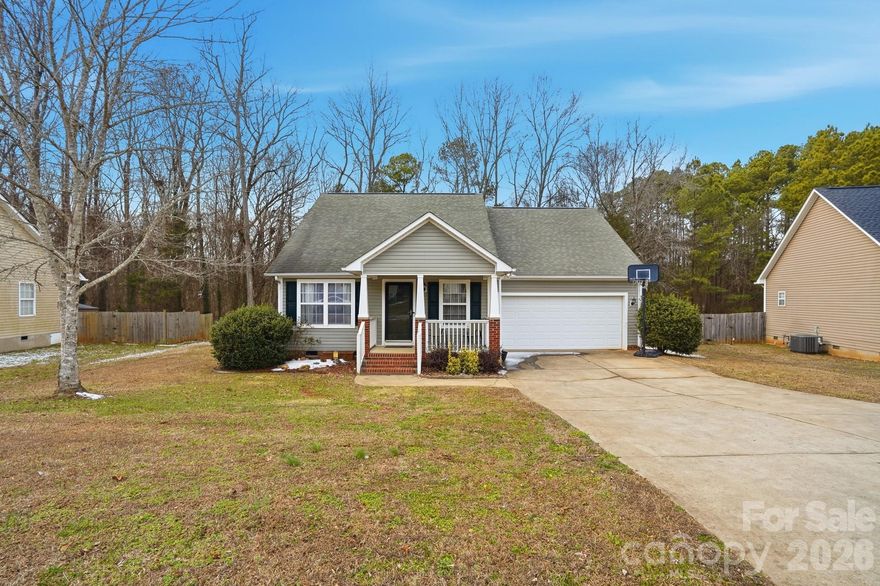Rare find in the Newport area of Rock Hill.  100% USDA financing eligible and NO CITY TAXES.  This lovely one-story home features 3 bedrooms, 2 full baths, a welcoming rocking chair front porch and a 2-car garage with ample driveway parking, all situated on .29 acres.  The fully fenced backyard offers privacy and peace, with rear gate access to a wooded buffer zone of trees, perfect for relaxing, pets, or play.  
Built by Infinity Designs, a well known local builder, this home offers an open-concept living area with vaulted ceilings and wood floors thoughout the great room and kitchen. 
There is also a cozy gas fireplace in the great room. The Kitchen comes complete with all stainless appliances including the refrigerator, an island with breakfast bar, a pantry, and dining area overlooking the backyard. 
Step out from the kitchen onto a 10x12 deck, ideal for morning coffee or evening grilling.   
There is a split bedroom plan for added privacy.  The primary suite boasts a vaulted ceiling, walk-in closet, and ensuite bath with dual vanity, tile flooring and garden tub/shower combo.  The two additional bedrooms are carpeted with the rear bedroom offering a walk-in closet.  
Zoned for Mt. Gallant elementary, Dutchman Creek middle school and Northwestern High, and conveniently close to Riverwalk Academy Public Charter School (K-12).  
FYI, Indoor Pex Plumbing was replaced in 2022.  The exterior water line to the road was replaced in 2025.  The HVAC was built in 2021.