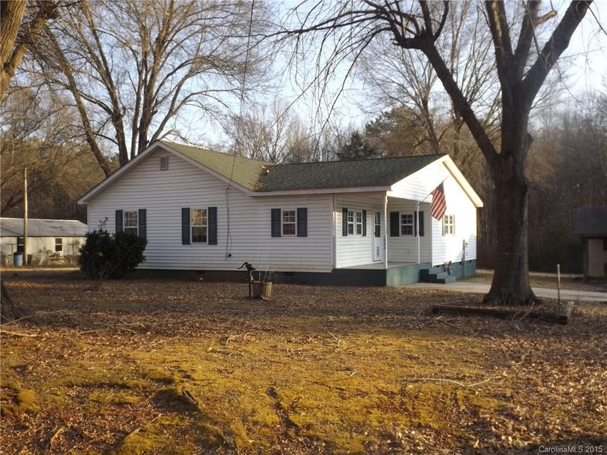 Great country home with workshop/storage area.  Located on a quiet street with large rooms and rocking chair front porch.  Mature trees with plenty of room for a garden!