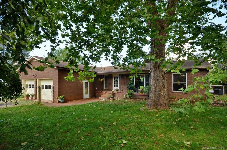 Charming Brick Rancher, with fenced in yard, wood floors, large great room, fireplace, outdoor patio, 2 car garage plus a detached workshop/studio!  This 2 bdrm/2 ba home is all one level living, with a gorgeous remodeled master bath with a vessel sink, beautiful tile, large master bdrm, bright kitchen with stainless refrigerator, double oven & a handmade tile backsplash.  Wonderful level yard with easy year round access!