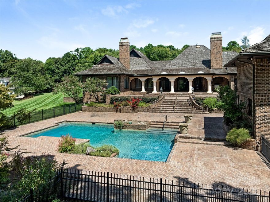 Exceptional Estate on Private Road - Welcome to this remarkable all-brick, 1-story estate offering nearly 6,000 sq. ft. of heated living space in one of South Charlotte’s most sought-after neighborhoods. Tucked away on a private road near Quail Hollow and Carmel Country Clubs, this residence blends timeless craftsmanship with modern comfort. Enter inside to high ceilings and stunning antique hand-hewn beams that anchor the main living spaces with warmth and character. The home boasts four bedrooms, four full baths and three half baths, along with abundant storage including a 1,200+ sq. ft. walk-up attic complete with a cedar closet. Multiple fireplaces create inviting gathering spaces plus, a dramatic wet bar in living room. Designed for both entertaining and everyday living, the floor plan flows seamlessly outdoors to expansive patios (with a 1/2 bath for the pool), a covered terrace and a sparkling pool—perfect for hosting or relaxing in privacy. A porte-cochere and four-car garage (with over 1,700sq ft) provide convenience and curb appeal. There is also a garage storage room and garage storage loft. Cedar shake roof and copper gutters compliment the exterior. This rare opportunity combines architectural detail, spacious design and a premier location—a true sanctuary just minutes from world-class golf, dining and shopping.