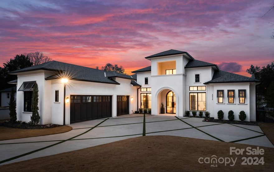 Luxurious one-level lakeside living on Lake Norman. Built two years ago with w/custom craftsmanship & design to create an exquisite home. Elegant driveway with diamond accents takes you past the 3-car garage to the beautiful arched glass door entrance. Light-filled foyer opens to great room with 12" ceilings throughout & 7" white oak flooring. Stunning kitchen w/ Wolf & Subzero appliances, 48-inch dual fuel range w/ custom zinc & brass hood, & leathered quartzite countertops. A glass-surrounded dining room offers expansive lake views. 3 sets of bi-fold back doors open to an outdoor living space, including built-in kitchen, recessed heaters, fireplace, TV, & outdoor half bath. Backyard leads to covered dock & boat lift w/ Wolf Serenity decking. Custom features incl. iron front & garage doors plus marble finishes, quartz countertops, Emtek hardware, Windsor windows & doors, & epoxy garage floors. An entertainer's dream while offering tranquility with year-round vacation-like views.