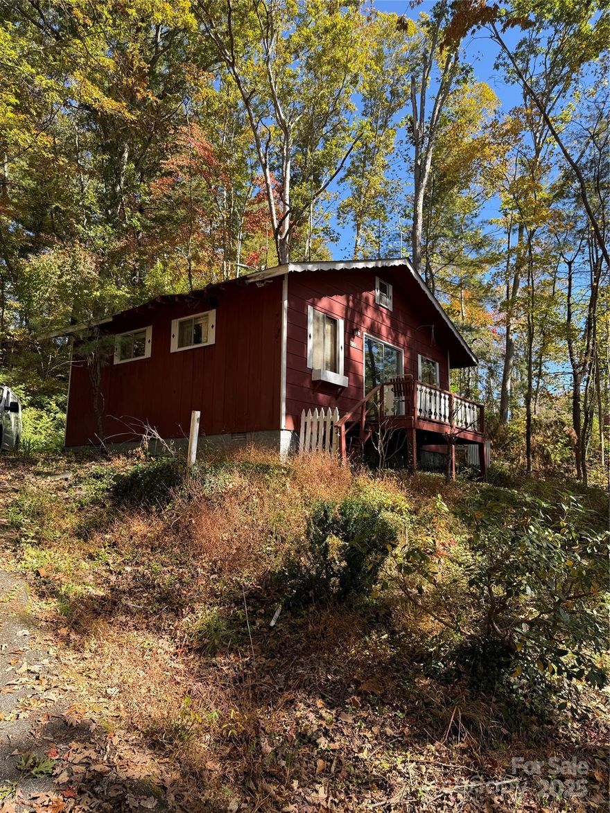 Opportunity Knocks in Greater Druid Hills, in ETJ of City of Hendersonville.  No city taxes. Formerly 1 bed 1 and 1/2 bath, this cute as a button Swiss style Chalet 500 sf  cottage sustained Hurricane Helene storm damage and it needs to be  taken down to the studs for ease of remodel. Sited in the middle of 2 of the 5 small original lots (lots 3,4,,5,6,and7 Greater Druid Hills block 9) which make up .84 acres.  Only a couple miles from Downtown Hendersonville!  Prior to the storm damage, home was used as a vacation rental.  So this could be your small home away from home or maybe a couple of vacation cottages or houses.  Priced ridiculously low to move quickly.