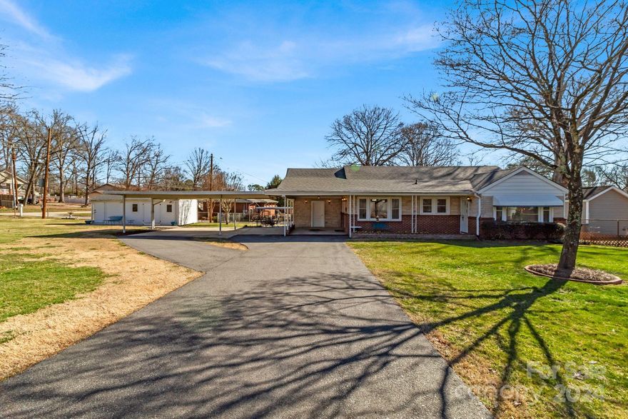 This charming, well-maintained 3 bedroom / 2 bath ranch sits on a .36-acre level corner lot. The outdoor space is perfect for gatherings that include the family dog, games, sports, food, and conversation. Enjoy bird watching while you sip your morning coffee or tea looking out the large picture window in the breakfast area just off the kitchen. The spacious living room is flexible for your needs with plenty of room for a dining table if you choose. The huge primary bedroom has a gas fireplace, sitting area, 2 large closets, and an ensuite bath. The two additional bedrooms are roomy with ample closet space. The large covered front porch and back patio add to the character of this home. An attached 3-car carport will protect you from the elements on those not-so-nice southern days. Two sheds provide plenty of space to store the garden tools, holiday decorations, and whatever else. This is your chance to own a beautiful home at an affordable price! Don't snooze and miss this opportunity!