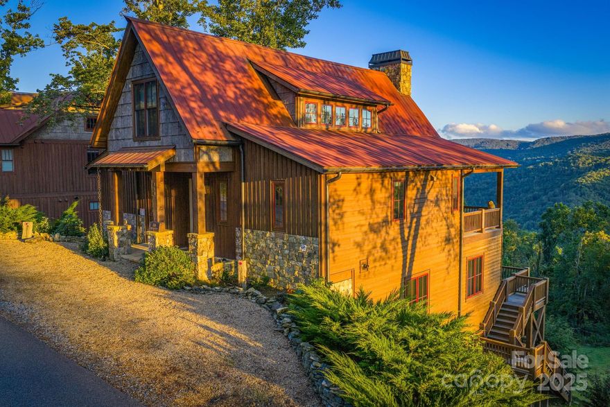 Great Investment Opportunity!! Priced to Sell at only $405 per sq ft. 
This amazing home is in the Village Section of the sought after Lodges at Eagles Nest. It was built to impress those looking for a luxury mountain style home that blends a rustic design and modern elements to create beauty and comfort. The WOW factor will catch your eye as you open the front door and discover the astonishing living area featuring massive glass windows bringing in magnificent views of the mountains and a floor to ceiling stone fireplace. The open floor plane combining the kitchen, living area and dining. The home features wood ceilings and hardwood floors throughout, stone and granite in the bathrooms, high quality cabinetry and the luxury granite countertops in the kitchen, huge butler pantry and featuring top of the line appliances. The entry level also offers the master bedroom with balcony, full bathroom with heated floors as well as the foyer, guest full-sized bathroom and laundry room. The loft area features a spacious bedroom and full-size bathroom as well as huge bonus area. The entertainment/game room on the first floor is just right for gathering family and friends for a fun time. This area offers two huge bonus areas, a full-size bathroom, gaming, exercise and sitting area with wet bar. Spend time sipping your coffee or that perfect glass of wine on the full size deck that opens from the game room area. There is nothing like enjoying the long-range views of the mountains and the astonishing sunsets from either of the three covered decks! The Village area provides maintenance free living with your yard being fully taken care of by the HOA. This house is offered fully furnished with a couple of exceptions. See exception list included as a document. Located in one of Banner Elk’s premier gated communities, The Lodges at Eagles Nest offers unmatched amenities, including: Five-Star Dining at the Epic Chophouse, 24/7 Dollar General convenience store, trout fishing, ATV & hiking trails for outdoor adventure, Outdoor amphitheater for concerts and community events, putt putt course, exercise room, pickleball, tennis courts, soccer fields, and much more.