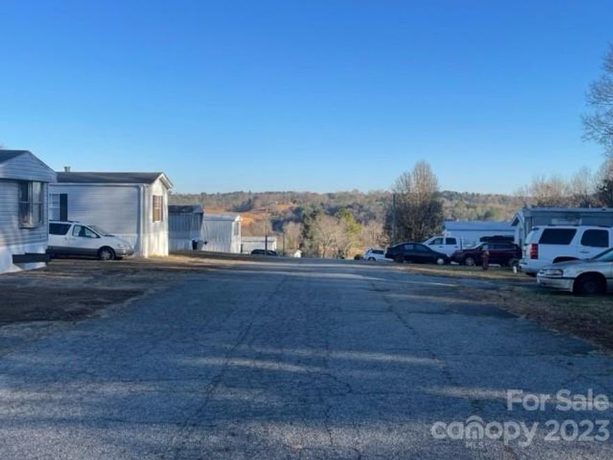 This 52 pad MHP offers a density that is difficult to find either on, or off the market in Western NC! The park contains mostly older singlewides, with 14 tenant owned units, 11 park owned units, 17 vacant park owned units, 10 vacant pads. The park features a gently sloping topography that offers pleasant views from the knoll top in the center of the property. MHP pads and units are served by a combination of individual and shared septics. Landlord covers trash/waste service, also city water/sewer billing. The opportunity exists to pass thru additional utility expenses to tenants. Zoned R-3 in Burke County. Convenient location only 7 miles to downtown Morganton and 9 miles to downtown Lenoir with high visibility and easy access off Hwy 64. All considered, this park offers an excellent opportunity for a value-add investor to create significant long-term cash flow with a good park density in a growing region that will see continued housing demand.