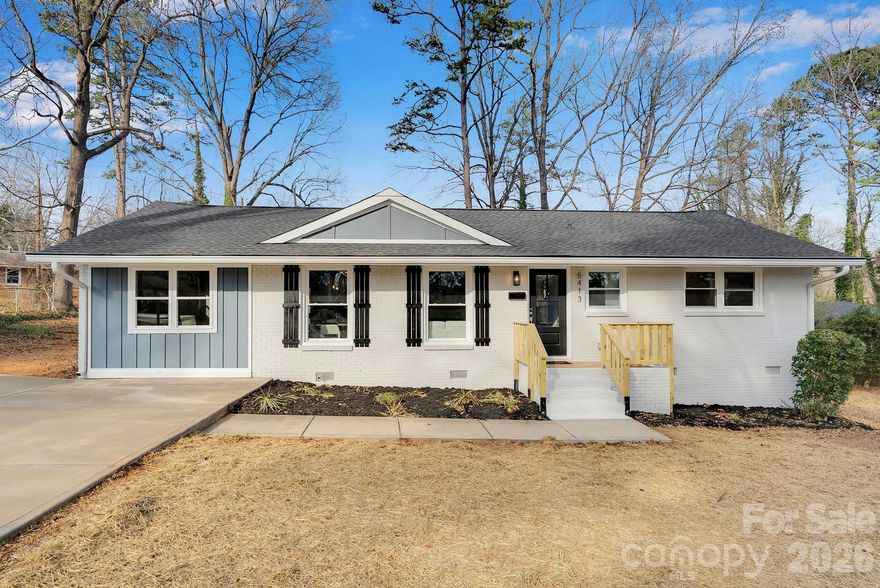 Welcome to 5413 Ruth Drive — a fully renovated brick ranch on a spacious .32-acre lot just minutes from Plaza Midwood and NoDa.

This 3-bedroom, 2-bath home offers 1,435 square feet of thoughtfully updated living space where classic charm meets modern design. Original hardwood floors have been carefully preserved and professionally sanded and refinished throughout, creating warmth and character you can feel the moment you walk in. Fresh paint, craftsman trim, updated lighting, and a sleek electric linear fireplace elevate the entire space.

The redesigned kitchen shines with all-new cabinetry, countertops, and appliances, plus a stylish flex space with frosted glass barn doors — perfect for a home office, coffee bar, or creative studio. Both bathrooms have been completely remodeled with new vanities, tile floors, updated fixtures, and tile-surround tub/showers. The former half bath has been converted into a private full bath off the primary bedroom, giving the home a true suite-style layout.

Major improvements include updated electrical wiring and panel, newer HVAC and ductwork, tankless water heater, vinyl windows, attic insulation, crawl space vapor barrier, and a roof replaced within the past five years — offering modern efficiency to match the fresh aesthetic.

Step outside to enjoy the newly built deck overlooking the fully fenced backyard with vertical wood slats. With .32 acres, there’s plenty of room to entertain, garden, relax, or expand your outdoor vision. A newly poured driveway and sidewalk, fresh exterior paint, board and batten accents, updated exterior doors, porch railings, lighting, and finishing details complete the polished curb appeal.

Renovated. Refreshed. Move-in ready.
Close to some of Charlotte’s most vibrant dining, shopping, and entertainment districts — this one checks all the boxes.