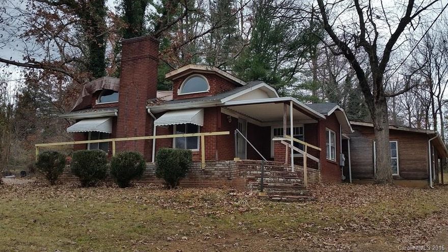 3 bed/2 bath home on 1 rolling acre in convenient Candler location. Home features wood flooring, formal living room w/ fireplace, galley-style kitchen, formal dining room, den, partial basement, detached garage, and attached carport/patio. Ready for new owners to renovate and make their own! Presumed to be on septic, but county has no record on file (not uncommon due to age of home). Buyers should verify info on MLS for accuracy as Seller/Listing Agent make no
representations.