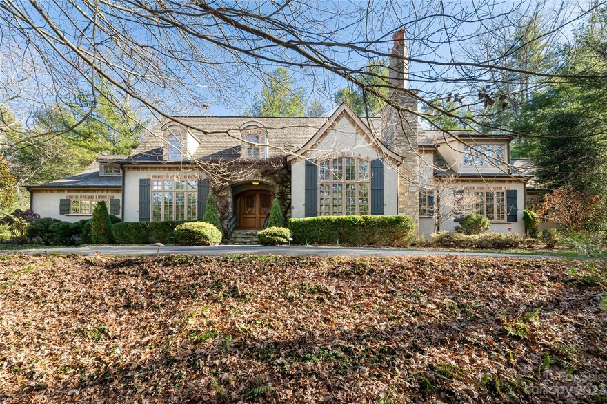 6 Fir Tree, a distinguished embodiment of French country architecture, commands attention while maintaining a discreet presence on a quiet road. This home sits proudly on a spacious 1.40-acre lot, radiating grandeur with impressively scaled rooms that speak to its refined design.The custom gourmet kitchen is a focal point, adorned with spectacular cabinetry, built-ins, beams, and a hearth room that adds an element of warmth. The connection to a private terrace elevates the indoor-outdoor living experience, offering a tranquil escape for relaxation or entertaining amidst the natural surroundings.The elegant formal dining area provides a setting for sophisticated dining experiences. The living room further enhances the home with soaring ceilings and a fireplace, creating a central gathering space. A French door-lined hallway leads to the primary wing, where an office is seamlessly integrated.The upper level offers three en-suite bedrooms and a bonus room. A must see in Biltmore Forest!