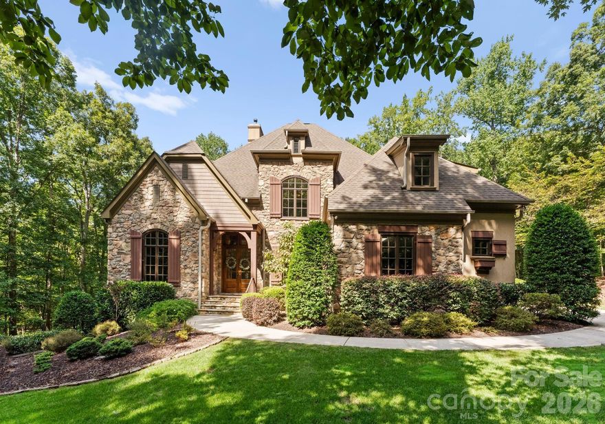 Set behind the gates of The Enclave, one of Concord’s most exclusive communities, this stunning custom stone and stucco residence rests on over two private acres framed by mature, scenic trees. Thoughtfully designed with soaring ceilings, exquisite moldings, and sun-drenched living spaces, the home combines timeless elegance with modern comfort. A finished basement creates an inviting space for entertaining, while the rear terrace with stone fireplace provides a serene retreat overlooking the wooded surroundings. The three-car garage and ample room for a future pool complete this remarkable property, all just 8 miles from charming Davidson and 10 miles from Birkdale Village—perfectly balancing private estate living with convenient access to premier shopping, dining, and recreation.