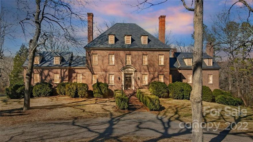 Brick pillars grace the gated entry to this stately mansion on 10 sprawling acres! Modeled after Carter's Grove Plantation, the Georgian architecture features Williamsburg imported bricks & slate roof with copper nails. Elegant craftsmanship incorporates period details with wood floors thru-out, lavish interior/exterior dentil moldings, a grand central staircase & vintage keys to entry doors! 10 wood-burn FPs accent the main Kitchen, DR & LR, Library, Owner's BR, 2 guest BRs up & 3 lower level rooms. Rooms for every purpose from formal & casual dining to parlor space by upper BRs. Home boasts 100 yr old salvaged wood beams, Delft china tiles, built-ins, mahogany paneled Library & 2 WIC in Owners BR. Lower level adds 2nd liv qtrs w/Kitch & DR, spacious Rec & Gathering rooms, BR & baths. 2 huge walk-in attics & 3rd floor walk-up attic offer copious storage. Outdoors, sweeping spiral stairs lead to a generous lamp post lit brick patio for gatherings overlooking the private grounds beyond.