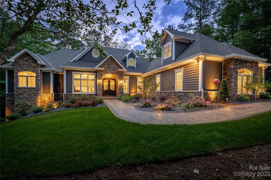 Exclusive luxury home completed in 2021 in the gated community of Plantation Pointe. Tucked into a quiet cove on Lake Hickory, this thoughtfully designed custom home is an entertainer’s paradise. Stunning lake views greet you the moment you enter. The spacious great room opens to a fully-screened outdoor entertainment area. Enjoy cooking in your gourmet kitchen, complete with Thermador appliances, six burner gas cooktop with griddle and pot filler, and vast center island. 10-foot vaulted ceilings and 8-foot doorways add to the expansive feel. The primary bedroom features built-ins and a bath with jetted tub and steam shower. Each additional bedroom boasts a private ensuite bathroom.  An elevator, 3-zone HVAC, 3 fireplaces, and tankless water heater offer convenience and efficiency.  The solar-powered hydraulic lift system converts the custom dock to a spacious pavilion. The level yard, well-illuminated, has room for a pool.  Rare opportunity to own this luxurious lakefront haven!