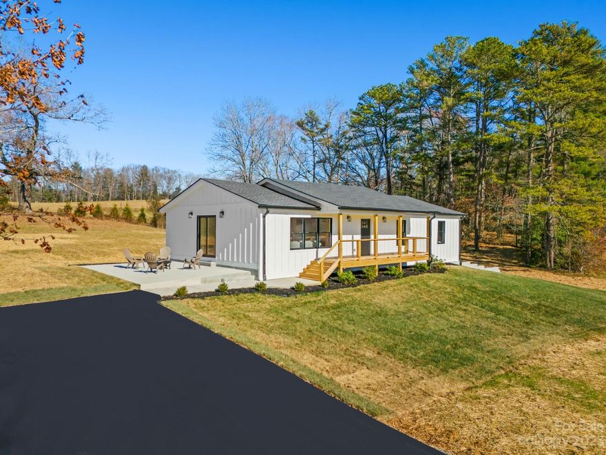 Experience refined country living in this renovated traditional home in Cane Creek. With 4 beds, 3 baths, and over 3,000 sqft of living space, it seamlessly combines classic charm and modern comfort. The living area, bathed in natural light, offers breathtaking mountain views. The beautiful kitchen features new appliances, fixtures, and granite countertops. Retreat to the primary bedroom with an en-suite bath. Unexpectedly, the lower level reveals an additional living area, bedroom, full bath, and a full kitchen with a private entrance—ideal for guests or potential rental income. Outside, the 1.1-acre property features manicured lawns and mature trees, creating a serene backdrop for outdoor gatherings against the backdrop of panoramic mountain views. Conveniently located, this home provides a perfect balance of rural tranquility and modern convenience. Embrace the charm of nearby shops and attractions within a short drive.  Live your dream in this mountain retreat—welcome home.