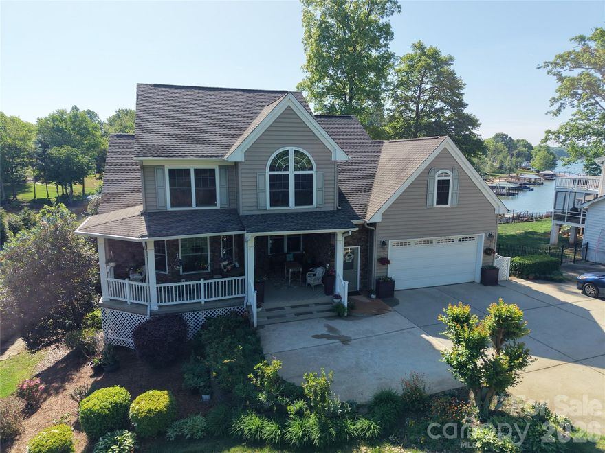 Rare opportunity to own a premier waterfront home on Lake Norman in the heart of Mooresville. Ideally positioned on a wide cove with deep, year-round water, this property offers the perfect balance of protected shoreline, quick big-water access, and beautiful views. With over 4,200 square feet, the home is designed for both comfortable everyday living and effortless entertaining.
A massive rear deck spans the back of the home, creating an exceptional outdoor living space for morning coffee, afternoons watching boating activity, or relaxing evenings overlooking the water. Enjoy peaceful lakefront sunrises from the back deck and stunning sunset views from the inviting front porch. The multi-tiered covered dock with seating area is ready for enjoying the Lake Norman lifestyle.
Inside, the flexible floor plan features two fully functional living areas. The finished basement includes complete second living quarters with its own full kitchen, laundry, and living spaces—ideal for multi-generational living, extended guests, or excellent short-term rental potential. The main level offers a spacious primary suite with large windows capturing morning sunshine and lake views, while upstairs features two additional bedrooms and a large bonus room. Washers and dryers in both the main-level and basement laundry rooms convey.
The septic system is located entirely in the front yard, preserving a generous flat backyard with ample room for a future pool overlooking the lake. This home has been meticulously maintained since construction, with the septic system and HVAC units professionally serviced twice per year. The windows carry a lifetime warranty, offering added long-term value and peace of mind.
Recent updates include a new roof in 2017, upstairs HVAC replacement in 2019, and basement HVAC installed in 2016. Not subject to HOA restrictions, with abundant parking and a prime location just minutes from shopping, dining, and everything Mooresville has to offer, this property presents a rare blend of lake lifestyle, flexibility, and strong short-term rental investment potential.
