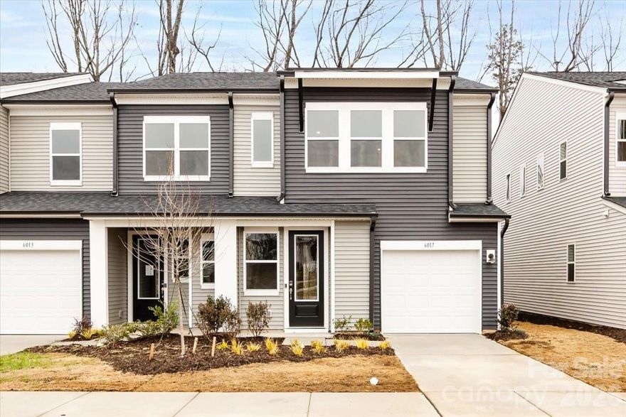 Set among mature tree lined streets at Fifteen 15 Cannon, 6017 Longar Lane offers a connected yet peaceful setting close to Uptown, NoDa, Camp North End, University and just 15 minutes from the airport. This Conrad plan is an end unit with added windows for abundant natural light, backs to a wooded area, and sits near community greenspace and walking trails. An extended 6' x 12' patio creates inviting outdoor living with both privacy and charm. Inside, a chef inspired kitchen anchors the first floor with a peninsula and large stainless steel farmhouse sink, white quartz countertops, a Zellige Neo Gesso Glossy tile backsplash, and rich grey cabinetry. Upstairs, the primary suite features a dual vanity and a shower with tiled walls and a tiled floor pan, delivering a refined and comfortable retreat.