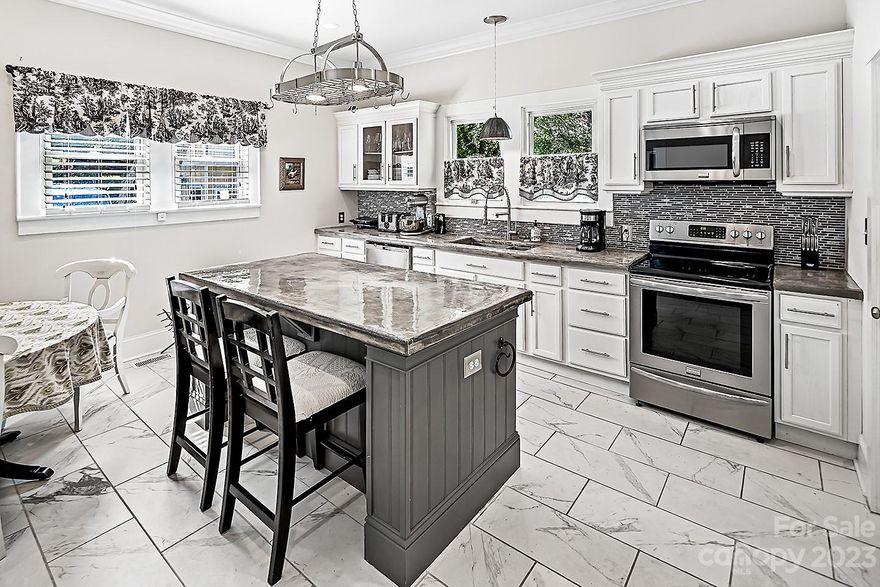 Nestled in Historic Gibson Village, this fully remodeled bungalow offers the luxury you deserve. Superb craftsmanship, tall ceilings, thick moldings, hardwoods, & more! The inviting living room features a custom built-in cabinet and fireplace, perfect for cozying up during chilly evenings or creating a focal point for gatherings.  The spacious kitchen boasts custom cabinets, large center island with sitting area, built in refrigerator, & stainless-steel appliances that are sure the please culinary enthusiasts. The luxurious primary retreat features a walk-in closet & private bath with custom tiled shower. The fenced backyard is a private oasis, offering a tranquil escape. Whether you prefer to entertain guests or simply enjoy some quiet time outdoors, the backyard provides the perfect setting. Overall, this home’s harmonious blend of classic & contemporary elements is a haven where you can enjoy both comfort & style, making it the perfect place to call home. Hurry, it won't Last Long!