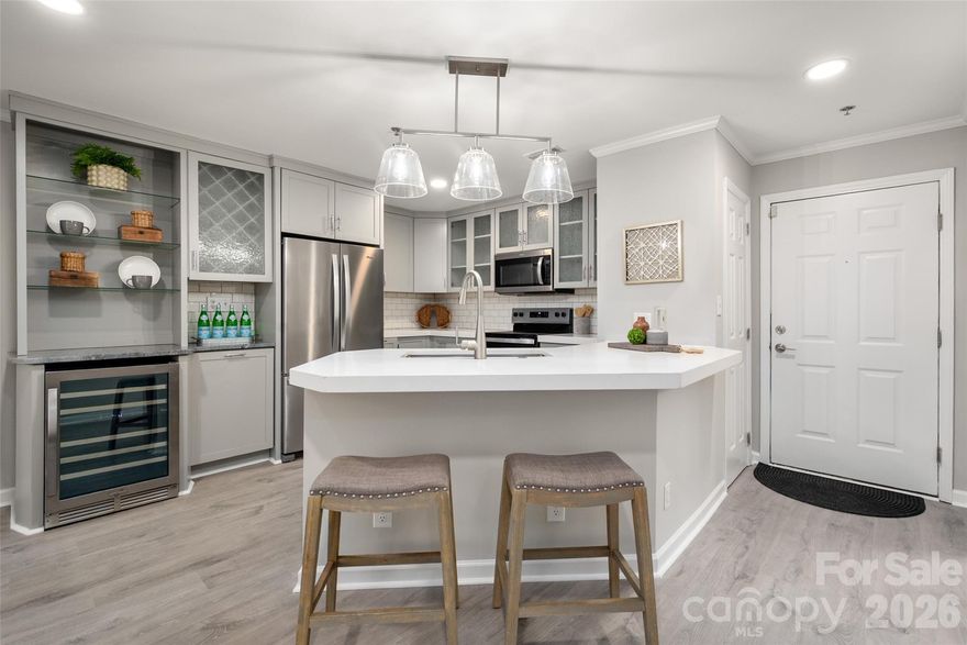 *Renovated Uptown condo with rare covered parking beside the entrance.
*Stylish kitchen with dedicated wine bar and open living space designed for entertaining.
*Located in the heart of historic Fourth Ward with quick access to parks, stadiums, restaurants, and light rail.
Updated 2-bedroom, 2.5-bath condo in Fourth Ward Square located in Uptown Charlotte’s historic Fourth Ward. Enjoy convenient access to Romare Bearden Park, Truist Field, Bank of America Stadium, Spectrum Center, the LYNX light rail, and many of Charlotte’s best restaurants, museums, and nightlife.
Bright, open interior with LVP flooring throughout and a thoughtfully designed kitchen featuring quartz countertops, subway tile backsplash, stainless steel appliances, rain glass upper cabinets, and a dedicated wine cooler with glass display shelving - perfect for entertaining!
The primary suite includes a spa-like bath with floor-to-ceiling subway tile shower, glass enclosure, and built-in niche. The secondary bedroom offers its own ensuite bath with subway tile surround, built-in niche with accent tile, and tub for relaxing. A separate powder room with vessel sink adds convenience for guests.
Private patio provides a great space to unwind or enjoy morning coffee. Two covered parking spaces located directly beside the entrance make Uptown living easy.
Fourth Ward Square amenities include a pool, fitness center, grilling areas, clubhouse, mini dog park, and pet stations throughout the community. Google Fiber available.