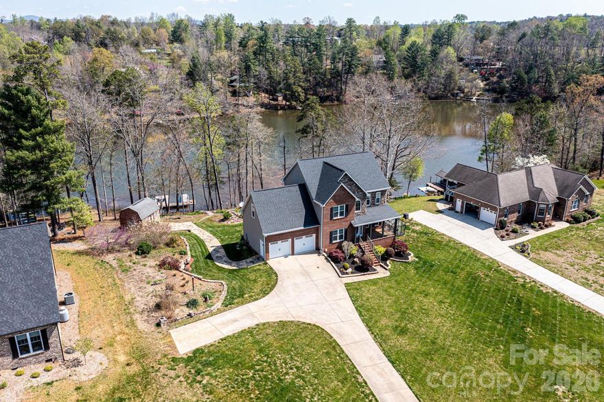 A true retreat for those who cherish lakeside living, this beautiful home offers over 3,400 square feet of thoughtfully designed heated space—providing plenty of room to relax, entertain, and unwind in serene surroundings. Enjoy peaceful sunrises over the water and stunning evenings from the main-level deck or the lower covered patio, both overlooking the Koi pond and tranquil cove views of Lake Hickory. A private floating dock invites endless waterfront enjoyment, perfect for boating, kayaking, or simply soaking in the beauty of lake life. Inside, the spacious kitchen features granite countertops and a stylish tile backsplash, ideal for preparing meals to share with family and friends. The adjoining family room, anchored by a cozy fireplace, creates the perfect setting for relaxing on cooler evenings. Upstairs, the home offers a restful escape with a generous primary suite, two additional bedrooms, and a large bonus room—perfect for guests, hobbies, or additional living space. The finished basement adds even more versatility with a recreation area and direct access to the covered patio and lake. For the hobbyist or gardening enthusiast, a brand-new greenhouse adds a special touch. This exceptional property is more than a home—it’s a lifestyle. This property is within 1/2 mile of a voluntary agriculture district.