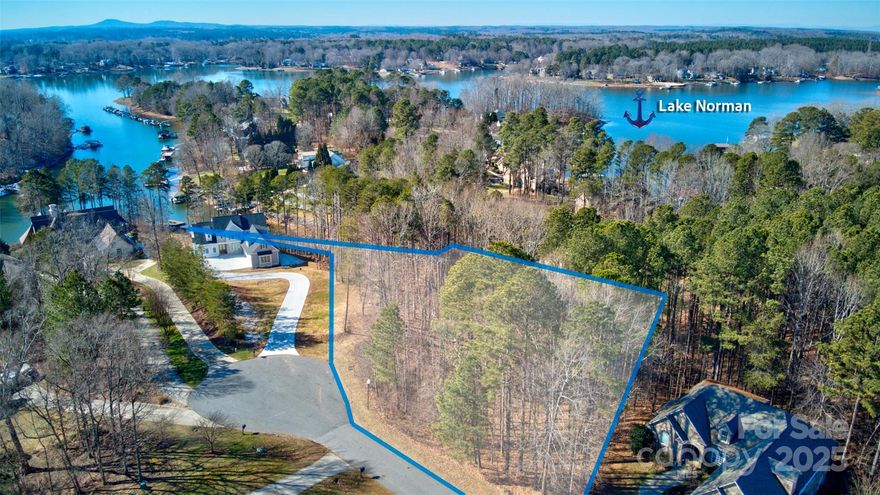 Discover your own private retreat on 1.7-acre waterfront lot in sought after Mooresville. This property offers unparalleled privacy & a gorgeous view of Lake Norman. A private dock is already in place, making it easy to enjoy boating, fishing, or simply soaking up the tranquil lakefront ambiance.

The lot's unique & varied topography presents an opportunity to create a truly one-of-a-kind custom home design, perfectly tailored to take advantage of the natural surroundings. Trees and lush foliage enhance the sense of seclusion, while the waterfront ensures easy access to lakefront living at its finest.

Conveniently located near dining, shopping, medical & entertainment, this rare gem is perfect for your dream home...Close to I77, Highway 150, Troutman...Whether you're looking to build a weekend getaway or a year-round sanctuary, this property promises a lifestyle of peace, beauty, and luxury. One of the best values on Lake Norman.
Bring your own builder!