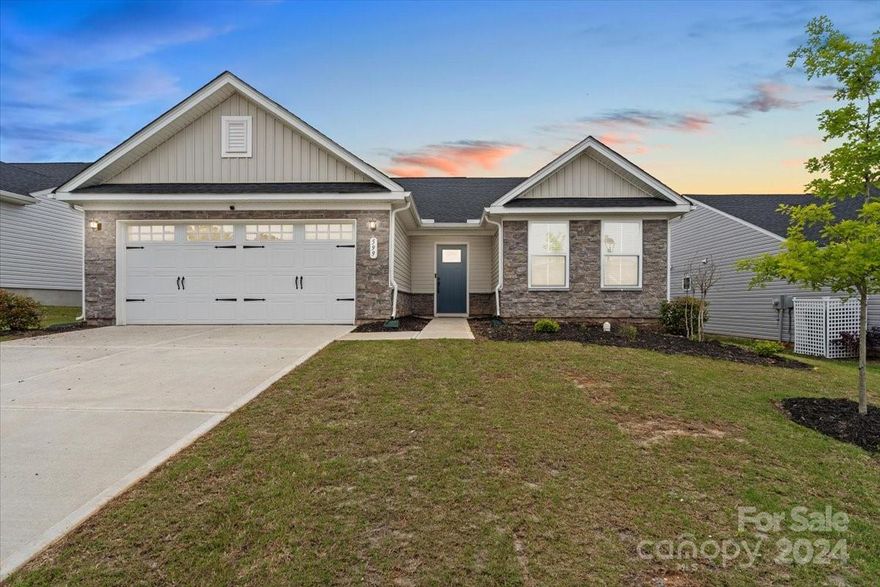 Welcome to your nearly new, craftsman-style ranch home. Built in 2022, this charming 3 bedroom, 2 bathroom home features a convenient split floor plan ensuring privacy and comfort without the wait of construction. The open layout combines a spacious kitchen - with granite counters, an island, and stainless steel appliances - with a dining area that opens to a cozy 14 x 10 patio. Perfect for easy entertaining and relaxed living! The primary suite offers a large walk-in closet and a double vanity bathroom with standalone shower, while the secondary bedrooms are well-sized with ample closet space. Take advantage of the double garage with extra room for larger vehicles. Plus, lawn care is covered by the HOA so you can focus on enjoying your new home. Ready to move in? This home is waiting to be yours!