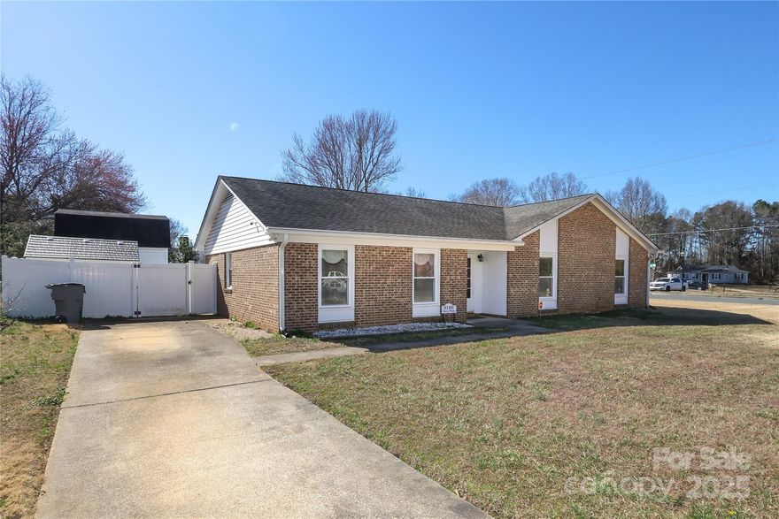 Welcome to this charming 3-bedroom, 2-bathroom home in a tranquil Charlotte neighborhood. Nestled on a spacious corner lot, this property boasts both privacy and curb appeal, enhanced by a fully vinyl-fenced yard—ideal for outdoor relaxation, entertaining with loved ones. The interior features a nice granite countertops and modern updates including renovated bathrooms. The cozy living area has a wood-burning fireplace. Recent upgrades ensure peace of mind and energy efficiency, with a brand-new HVAC system and water heater installed in June 2024. In May 2021 were installed a new seamless gutters. Best of all, this home is free from HOA. Located conveniently near schools, shopping, and major highways, the home also comes with added value, as the sellers are including a security system, cameras, refrigerator, washer, dryer, and two sheds with an acceptable offer. This house offers a lot of potential to make it your forever home, the house will sell as is with no repairs, thanks