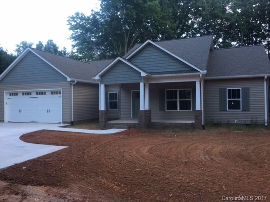 NEW CONSTRUCTION 3 BR 2.5 BA home on a private lot with lots of upgrades! Kitchen offers tons of cabinets/counter space, granite countertops, tiled backsplash & breakfast area. Very nice master bedroom suite with tiled shower, freestanding soaking bathtub, his & her vanities and a huge walk-in closet.  Other features include split BR floor plan, spacious bedrooms, wood floors, crown molding, front porch, covered back porch, 2 car garage, private wooded lot & much more! Too many features to list!