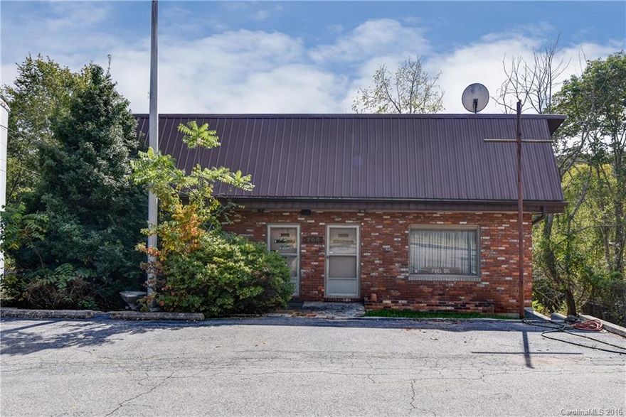 Great value with New Leicester Hwy frontage office building. Features basement with rollup garage door. Appraisal on file.