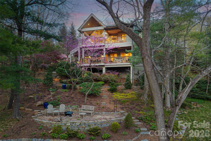 Carefully maintained, this exquisite home is set within the prestigious community of Reynolds Mountain and backing to a 16-acre private nature preserve, this residence offers an incredible location defined by wooded privacy, treetop vistas and daily immersion in nature, just 10 minutes from downtown Asheville. Here, a rare park-like setting unfolds with serene gardens, tiered stone terraces, and native plantings that feel curated and beautifully organic. Expansive covered and open-air decks create seamless indoor-outdoor living, inviting mountain sunsets, alfresco dining and quiet moments of reflection. A covered outdoor kitchen appointed with a Viking grill elevates gatherings with effortless style. Inside, walls of soaring windows frame year-round mountain views and bathe the home in natural light, enhancing the home’s smooth and creative spaces. The great room, anchored by vaulted ceilings and a dramatic stacked-stone fireplace, flows gracefully into a renovated kitchen featuring granite surfaces, stainless steel appliances, a custom island and a generous walk-in pantry. Rich tigerwood floors add warmth and continuity throughout. The main-level primary suite is a private sanctuary with vaulted ceilings, direct deck access and a spa-inspired bath. A bespoke corner office offers an inspiring work-from-home retreat. Designed for relaxation and entertaining, the lower level reveals a home theater, wet bar, expansive family room opening to a private deck, guest suites and flexible bonus space to suit your vision. Thoughtful upgrades, Energy Star efficiency and a three-car garage enhance everyday comfort, while the home’s coveted lock-and-leave ability ensures ease of ownership. Blending refined sophistication with the restorative beauty of its natural surroundings, at an incredible price, this is mountain living at its most compelling.Being sold AS IS at this incredible price.Seller is very motivated to get the home sold they are relocating.