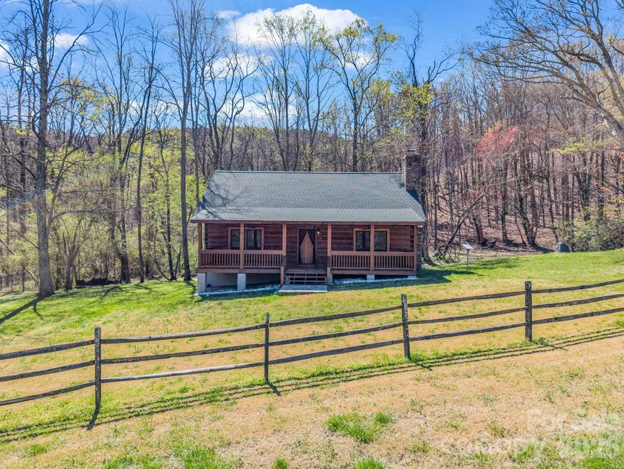 Nestled on 5 private acres with mountain views in the scenic countryside of Landrum, this beautifully maintained Southland log cabin offers the perfect blend of rustic authenticity, comfort, and peaceful Upstate living. Lovingly used as a second residence since its construction, the home has seen limited wear and remains exceptionally well cared for. 
This true log home features 2 bedrooms and 2 baths, including a spacious primary en-suite with striking stone flooring and stone-surround tub/shower. Warm mahogany wood floors run throughout most of the cabin, complemented by exposed wooden beams and a welcoming open floorplan—all on one level for easy living.
At the heart of the home is a stunning Tennessee fieldstone chimney and fireplace, highlighted by a custom live-edge mantel crafted from a log found right on the property—an unforgettable centerpiece that reflects the home’s authentic character and craftsmanship. 
Step outside and enjoy the serenity of a year-round stream flowing behind the cabin.  The property borders 93 acres of protected conservancy land, offering exceptional privacy and a true connection to nature. The property also includes a 2-stall run-in shed with tack/feed room, electricity, hot water, and fenced pasture, making it ideal for equestrian use or hobby farming. 
Additional highlights include a new roof installed in 2021 and the timeless appeal of a genuine log interior throughout—no sheetrock—creating a warm and distinctive mountain-style retreat.
Whether you're searching for a peaceful full-time residence, weekend getaway, or equestrian-friendly escape near Landrum’s charming downtown, this property delivers privacy, craftsmanship, and natural beauty in one exceptional setting.