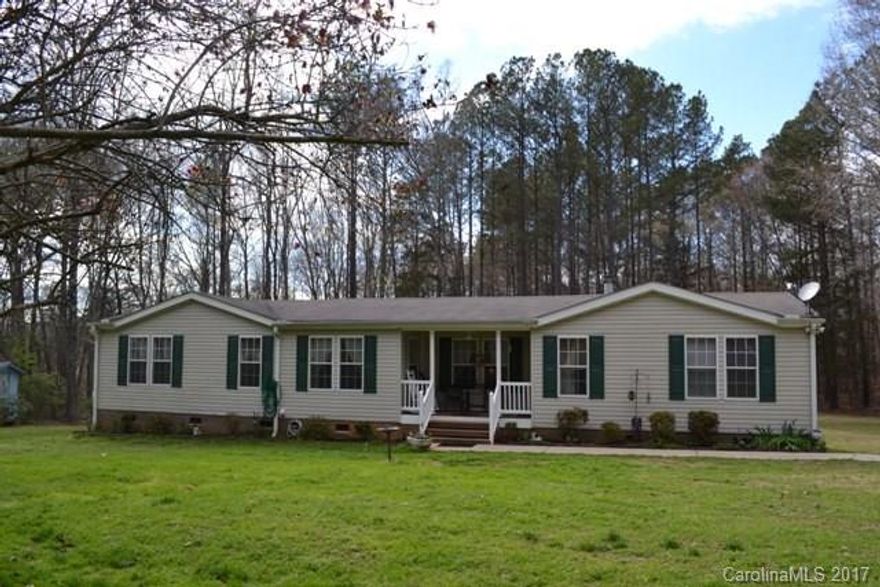 A very unique and beautiful setting. This property has a doublewide and a singlewide. Great for rental income or family situation. These remarks are for the doublewide: Huge great room with fireplace, spacious kitchen has a work island and a dining room. Split bedroom plan and a front porch. Partially fenced backyard with an above ground pool with a newer sand filter. There is a creek on the property as well. The singlewide has 2BR, 2BA and is handicapped accessible. AS IS SALE.