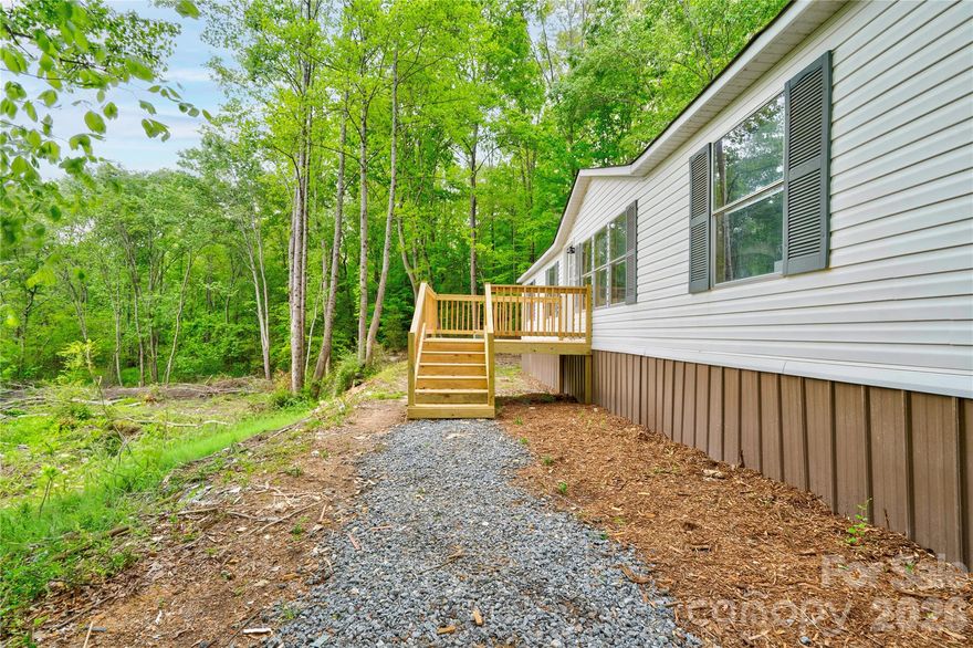 This beautifully updated 3-bedroom, 2-bathroom double wide offers the perfect opportunity for those seeking space, privacy, and a true escape from the hustle and bustle. Tucked well off the road, the home is not visible from the street, creating a peaceful and secluded setting surrounded by nature.The home has been thoughtfully updated and features new flooring throughout, fresh interior paint, an updated kitchen and bathrooms, a new HVAC system, and a new roof. A freshly graveled driveway leads you into the property, adding to both functionality and curb appeal. The land offers a unique blend of usability and natural landscape, with a portion located within a floodplain.  Conveniently located approximately 25 minutes from Shelby, this property provides the perfect balance of rural living with access to nearby amenities. If you’ve been searching for acreage, privacy, and an updated home, this is one you don’t want to miss!